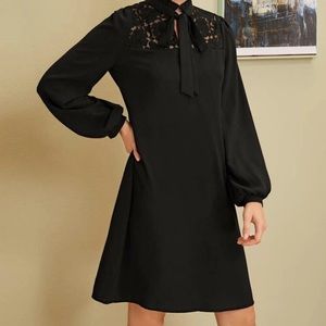 A tie neck lace dress